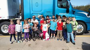 kids in front of a truck with trucker buddy