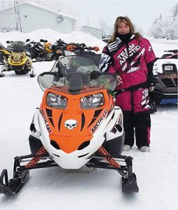 Joanne with a snowmobile