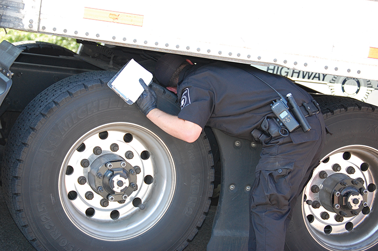 officer inspecting big rig