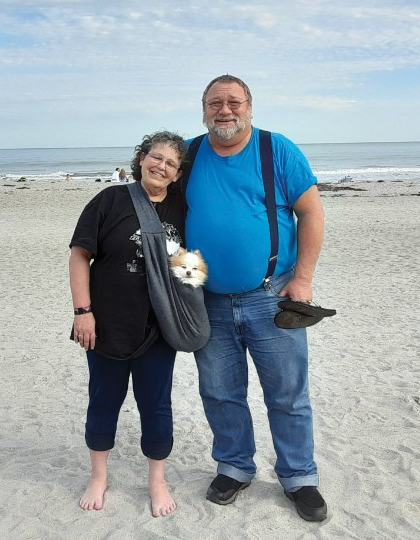 trucking couple on the beach with pomeranian