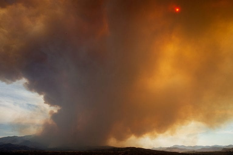 Highways closed, rural Arizona residents wait as wildfire spreads uncontained