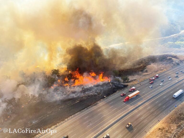 Firefighters advance on blaze that shut California highway