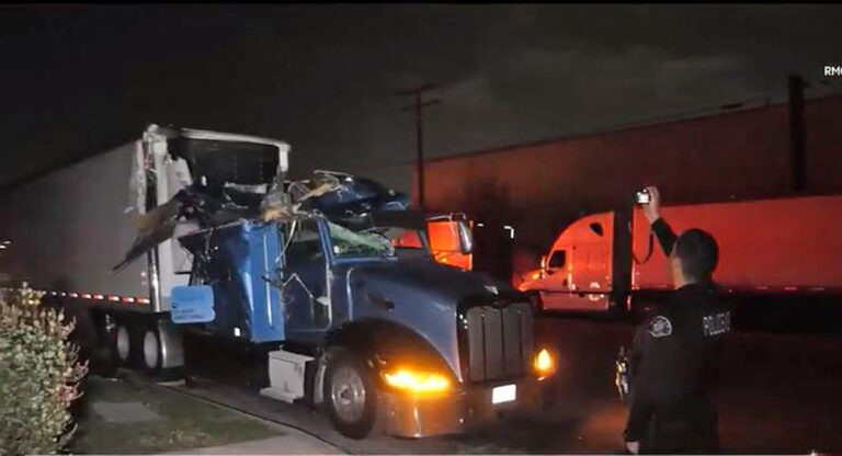 Car clips top of big rig while trucker sleeps inside