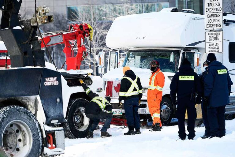 Crews begin towing trucks at Ottawa protest, arrests continue