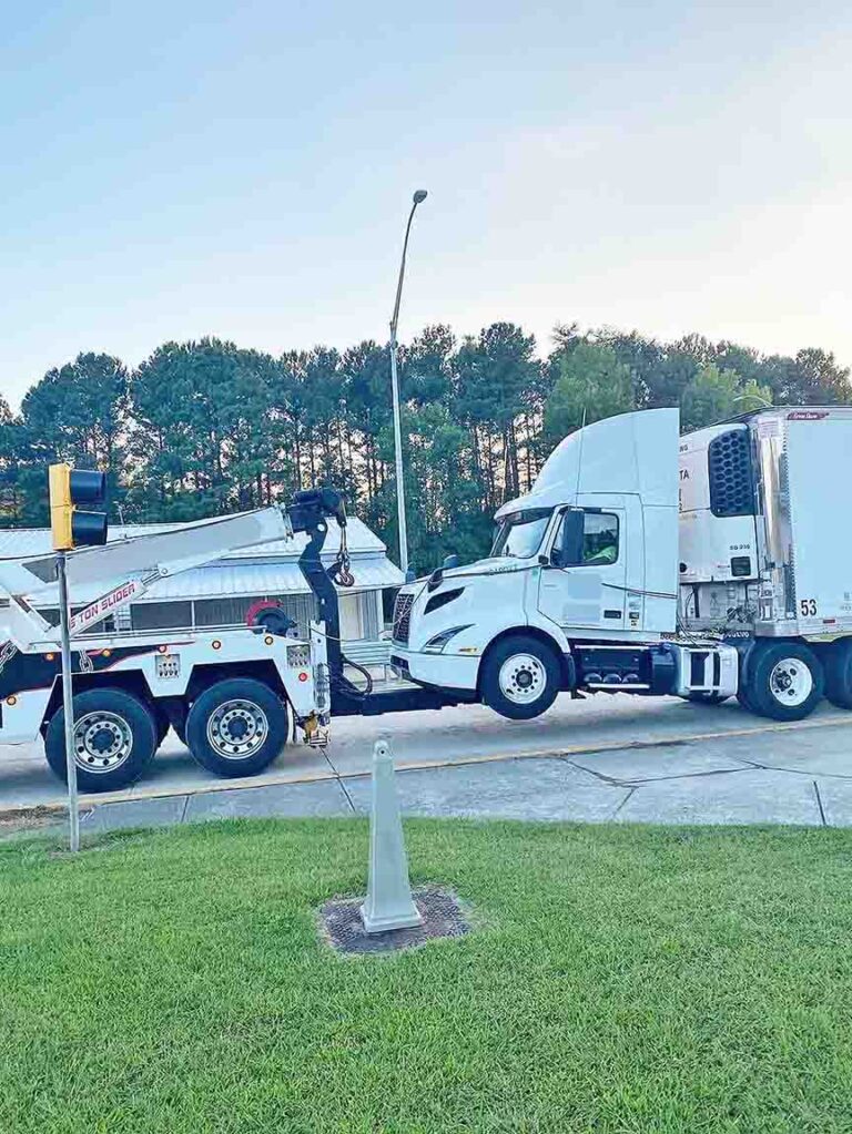 Tow truck driver without CDL cited for hauling big rig with driver still inside