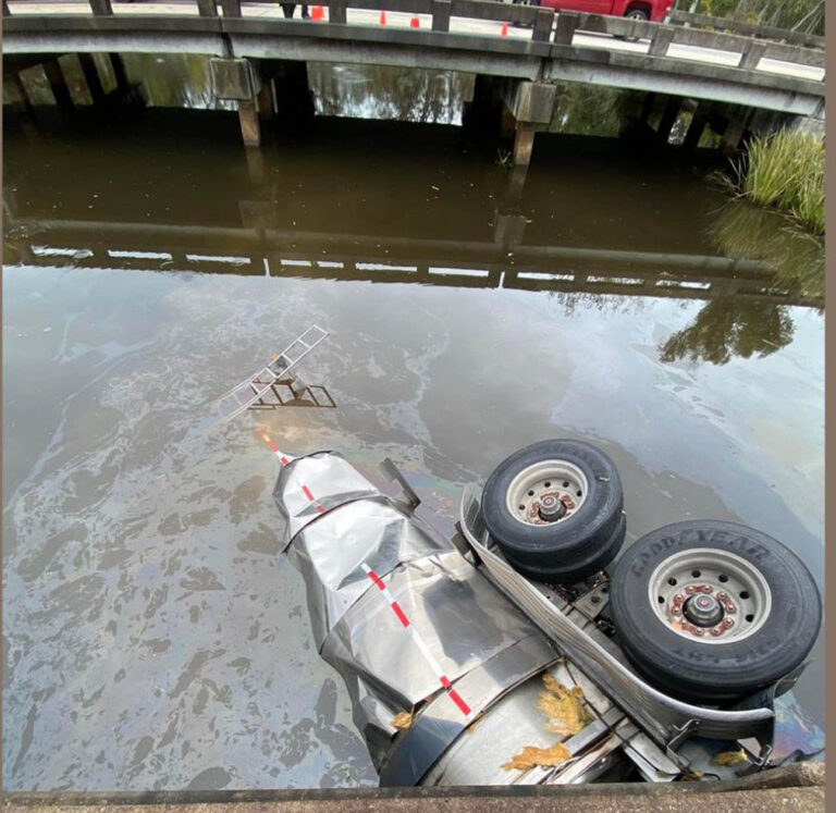 Tanker truck driver survives crash off I-10 bridge