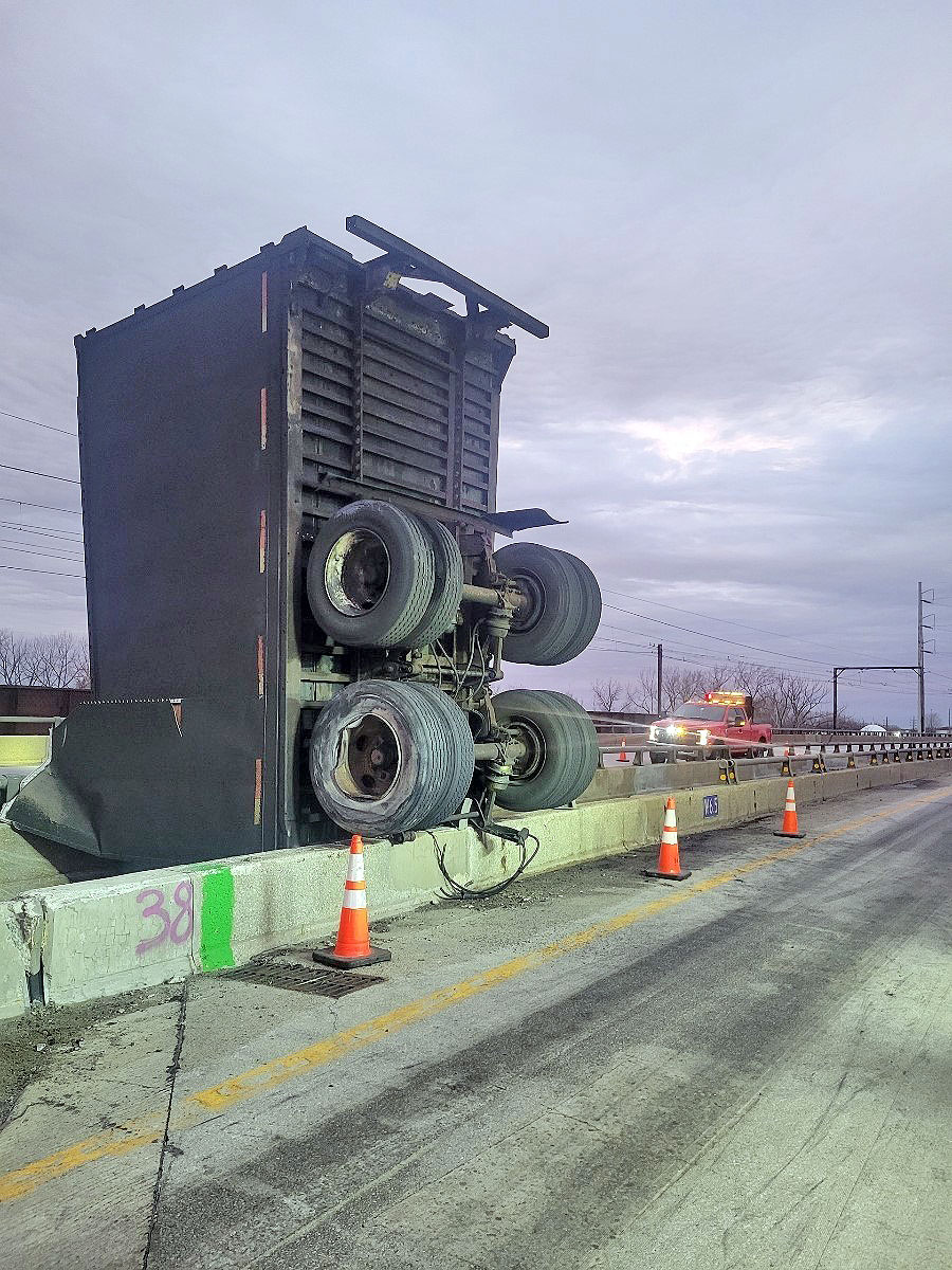 Truck driver found clinging from bridge after big rig plunges into ...