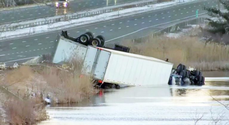 2 tractor-trailers crash on a Connecticut highway and land in a pond, killing 1