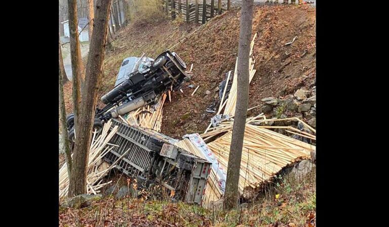 Driver missing after big rig hauling lumber tumbles down West Virginia hill