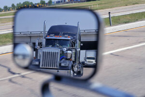A big blue truck in the vehicle mirror