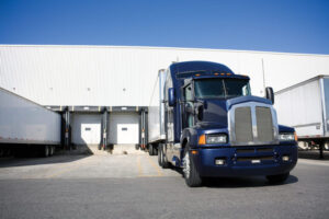 Blue Tranport Truck Docking in warehouse