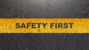 'Safety first' text on the asphalt road