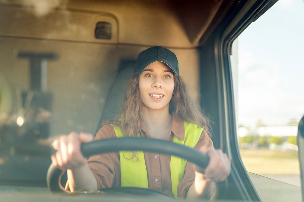 Female driver looking out of truck window.