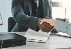 Lawyer, office and shaking hands for success in meeting, partnership and agreement or deal at a law firm. Professional attorney, notary and clients handshake for thank you, onboarding or consultation