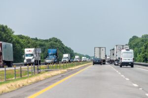 Highway i40 interstate road in Arkansas with heavy traffic of many cars trucks driving point of view pov in summer