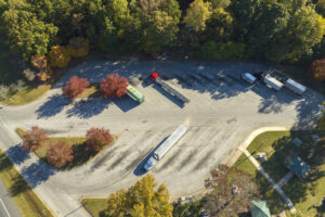 Large truck stop with resting area near busy american interstate freeway with fast driving cars and trucks. Recreational parking place during interstate travel