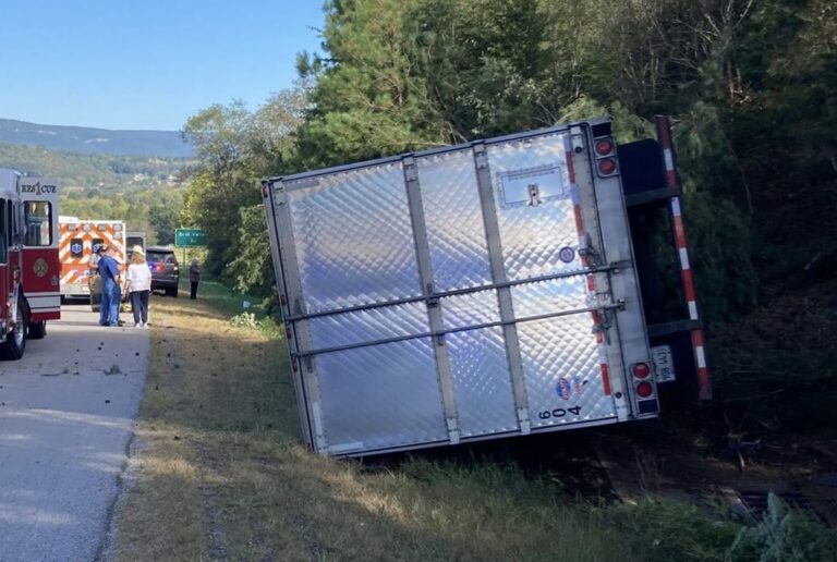 Trucker trapped, uninjured in overturned rig carrying milk