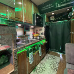 A green curtain divides the sleeper and living area from the cab of The Goose. (Linda Garner-Bunch/The Trucker) The Goose Sleeper, View 1