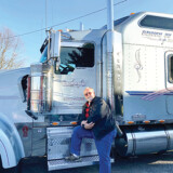 Mark Buckwalter drives a gray Kenworth W900 while his son, Lamar Buckwalter, drives a red one of the same model. (Photo by Lane Buckwalter)