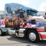 A patriotic montage and the reminder, “All gave some; some gave all,” adorn Mack Trucks’ custom-wrapped Mack Anthem military-themed tractor. (Courtesy: Mack Trucks)