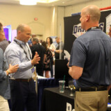 Attendees gather during Monday evening’s reception in the exhibition hall. (Courtesy: TCA)