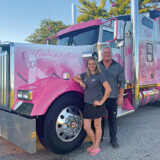 Eva Knelsen, left, and West Coast Transportation owner Don English pose beside the company’s breast-cancer awareness truck, which Knelsen proudly drives. (Courtesy: Eva Knelsen)
