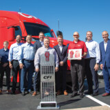 CFI President Greg Orr (holding plaque) is joined by Steve Studer, director of maintenance (far left) and Randy Cornell, vice president — maintenance (next to Studer) as dignitaries from the OEM and dealer present CFI’s 15,000th Kenworth truck in a September 2021 ceremony. Those Who Deliver 1
