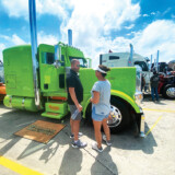 The Trucker's John and Megan Hicks discuss the merits of a tractor while judging the Super Truck Beauty Contest. (Linda Garner-Bunch/The Trucker)