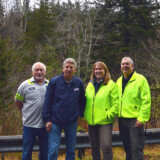 A group from Hardy Brothers Trucking is shown in front of the 2022 Capitol Christmas Tree before its harvesting from North Carolina’s Pisgah National Forest in early November. From left, Ricky Watts, director of driver training; Dale Norman, director of sales and marketing; and husband-and-wife team drivers Ed Jr. and Deb Kingdon. (Courtesy: Truck PR)