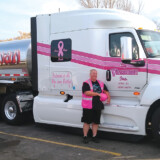 Tanker driver Nan Harguth wanted her truck to stand out at events, so she asked for a pink truck. In addition to pink stripes, her International features pink ribbons and slogans about fighting cancer. (Courtesy: Cliff Viessman Inc.) Nan Harguth 1