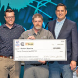 Knight Refrigerated driver Richard Boehrer, shown at center, poses with his $20,000 check for being a new Professional Driver of the Year. (Courtesy: TCA) 23 03 07 Boeher TCA web