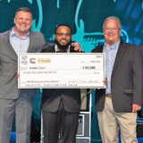 Classic Carriers driver Daniel Clark, shown at center, is all smiles with his $20,000 award check for being one of the newest professional drivers of the year. (Courtesy: TCA) 23 03 07 Clark TCA web