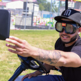 A student at Patterson High School’s truck driving course maneuvers a golf cart, hauling a 7-foot utility trailer, while wearing “Fatal Vision” goggles that simulate the effects of driving while under the influence of alcohol or other substances. (Courtesy: Patterson High School) Patterson High 1