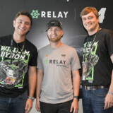 Relay Payments co-founders Spencer Barkoff (left) and Ryan Droege (right) pose with NASCAR driver William Byron before the race. (Courtesy: Nigel Kinrade Photography)