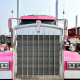 Eva Knelsen says she loves traveling the highways in Ken Worth Jr., a pink and white W900L that honors cancer survivors. (Linda Garner-Bunch/The Trucker)