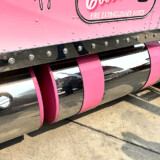 Eva Knelsen says she loves traveling the highways in Ken Worth Jr., a pink and white W900L that honors cancer survivors. (Linda Garner-Bunch/The Trucker)