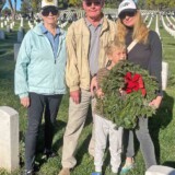David and Susan Whitebread of Iowa, along with their daughter, Katy, and grandson, Ryder, of Valley Glen, Calif., pay tribute to friend Stan Howard, a Vietnam veteran who died over the past year, by laying wreaths at the Los Angeles National Cemetery as part of Wreaths Across America on Saturday, Dec. 16, 2023. (Bobby Ralston/Trucker News Staff) Wreaths Across America at Los Angeles National Cemetery