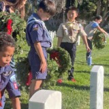 Members of Cub Scout Pack 862 from Gardena, Calif., show support to veterans by participating in Wreaths Across America on Saturday, Dec. 16, 2023, at Los Angeles National Cemetery. (Bobby Ralston/Trucker News Staff) Wreaths Across America at Los Angeles National Cemetery