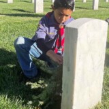A member of Cub Scout Pack 862 from Gardena, Calif., shows his support to veterans by participating in Wreaths Across America on Saturday, Dec. 16, 2023, at Los Angeles National Cemetery. (Bobby Ralston/Trucker News Staff) Wreaths Across America at Los Angeles National Cemetery