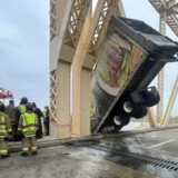 This photo provided by the Louisville Division of Fire shows a semi-truck dangling from an Ohio River bridge on Friday, March 1, 2024. bridge3
