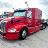 Brandon Myher took home first place in the Working Truck: Company Truck-Combination category with “Fancy,” a cherry red 2023 Peterbilt 579 and 2019 Reinouer step deck trailer. (Linda Garner-Bunch/The Trucker)