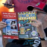 A Jamboree attendee checks out the events and feature stories in this year's Walcott Truckers Jamboree guide. (Courtesy: Iowa 80 Group)