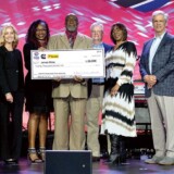 During TCA’s 2024 convention in Nashville, White was honored for his accomplishments. He proudly displays a prize check, surrounded by his family and members of the P&S Transportation team, along representatives of TCA, Cummins and Love’s Travel Stops. (Courtesy: Truckload Carriers association)