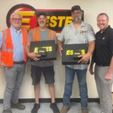 From left: Curtis Carr, vice president of safety and risk management for Estes, Wade Burcham, Tyrone Burcham and Ron Giordon, Estes’ regional vice president, celebrate the brothers’ safety achievements on the road.
