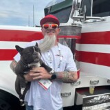 Gary Dean Jones Jr. and his French Bulldog, “Scooter,” pose by EZE Money, a 1999 Peterbilt 379, during the 2025 Mid America Trucking Show, held in Louisville, Kentucky, March 27-29. (Linda Garner-Bunch/The Trucker)
