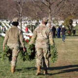 Each year, volunteers work to place wreaths on gravestones at veteran cemeteries across the U.S. and abroad. (Photo courtesy of Wreaths Across America)